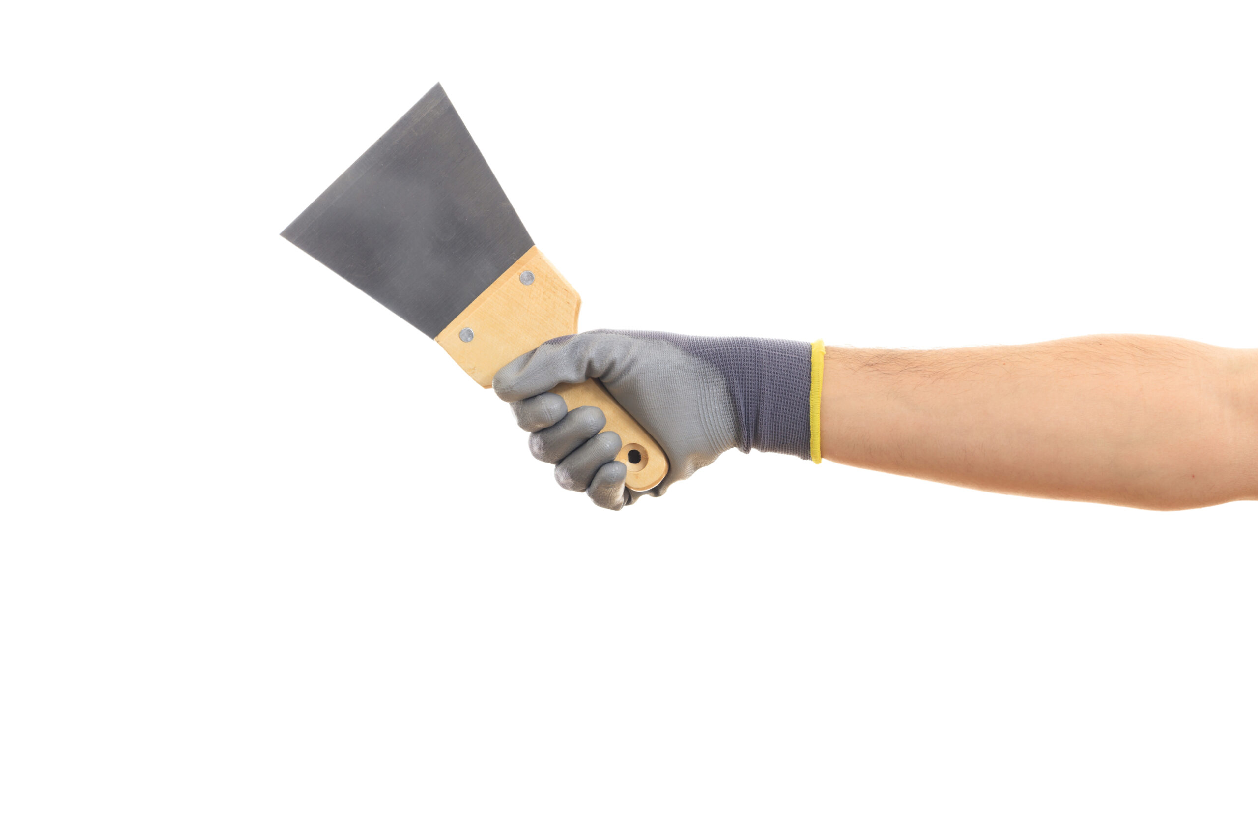 hand holding a drywall spatula.